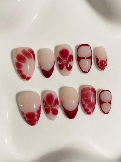 Red 10 Piece French Style Almond Shaped Press Nail Set, Decorated With Flowers And Asymmetrical Red Color Blocks, Featuring A Hot Girl Style Christmas And New Year Outfit. The Elegant And High-End Red Nail Set Is Adorned With Gold Small Steel Balls. It Is A Fully Removable Fake Nail Set Suitable For Office Workers, Students, Party Girls, And Nail Supplies Of All Seasons. It Comes With 1 Jelly Glue And 1 Nail File.