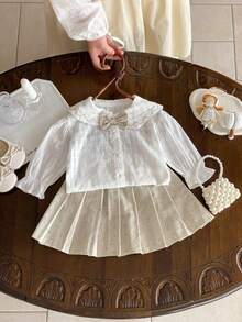 Set de 2 piezas Estilo francés dulce y preppy para niñas, blusa con cuello con volantes y lazo + falda plisada con estampado floral, corte holgado (talla arriba una)