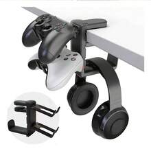 Un nuevo y versátil soporte dos en uno para auriculares y mando de juegos, con capacidad para dos mandos y un auricular. También sirve para colgar auriculares y otros artículos. Es perfecto para usar en casa, en la oficina, en un estudio, en una residencia universitaria o junto al televisor. - Negro - Ver 1