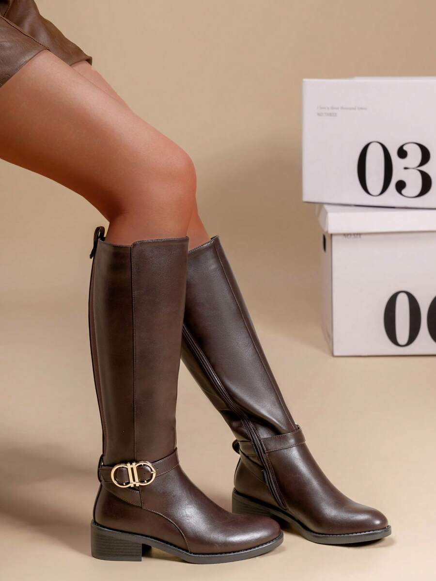 calcena Women's Elegant Knee-High Riding Boots Featuring A Comfort-Fit Stretch Back Panel, Decorative Ankle Strap With A Gold-Tone Infinity Style Buckle, And A Low Block Heel For Everyday Wear - Brown - View 1