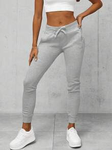 Pantalones deportivos sencillos de color liso con bolsillo frontal con lazo para mujer, informales para uso diario
