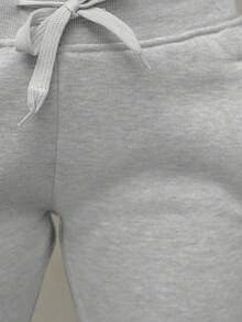 Pantalones deportivos sencillos de color liso con bolsillo frontal con lazo para mujer, informales para uso diario