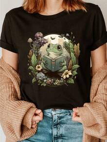 Women's Cottagecore Aesthetic Black Mouth T-Shirt – Adorable Frog Reading A Book With Vintage Floral And Mushroom Print, Casual Short-Sleeved, Crew-Neck Top In Soft Cotton For Summer And Spring, Everyday Comfort, Playful Graphic Mouth T-Shirt, Breathable Fabric - Black - View 1