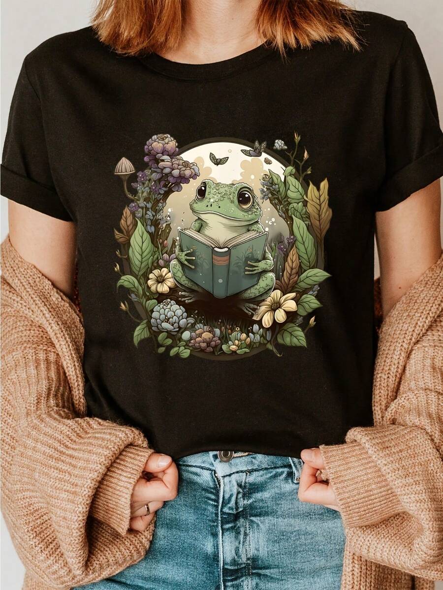 Women's Cottagecore Aesthetic Black Mouth T-Shirt – Adorable Frog Reading A Book With Vintage Floral And Mushroom Print, Casual Short-Sleeved, Crew-Neck Top In Soft Cotton For Summer And Spring, Everyday Comfort, Playful Graphic Mouth T-Shirt, Breathable Fabric - Black - View 1