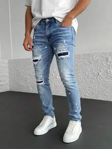 Pantalones vaqueros azules con rotos y efecto de salpicadura, tiro alto y corte entallado, estilo vanguardista y personal - Lavado ligero - Ver 2