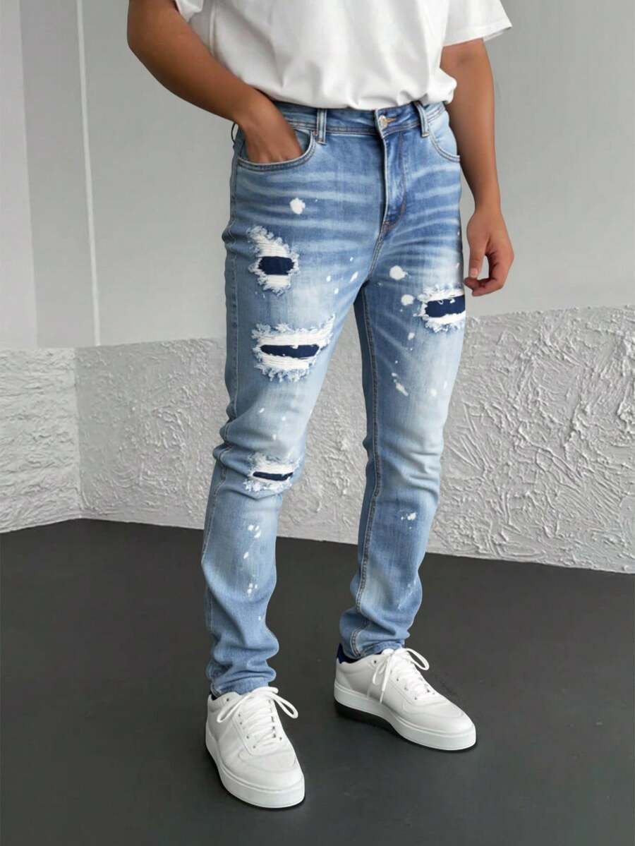 Pantalones vaqueros azules con rotos y efecto de salpicadura, tiro alto y corte entallado, estilo vanguardista y personal - Lavado ligero - Ver 1