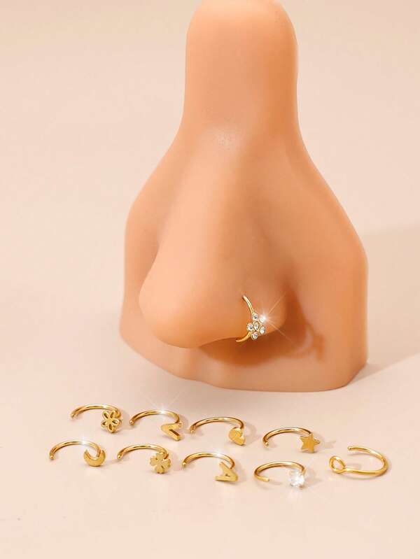 Conjunto de 10 lindas argolas de nariz em formato de coração, em diversos estilos. Piercings de nariz hipoalergênicos de zircônia banhados a ouro 18K em formato 20G-C. Inclui lua, estrela, trevo de quatro folhas, flor, letra e brincos. Adequado para uso diário. Mini argolas de nariz.