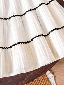 Young Girls Elegant Outfit - Short Puff Sleeve Top Paired With High-Waisted Skirt. The Puff Sleeve Design On The Top Is Playful And Cute, Flattering The Arm Line. The Multi-Layer Skirt Sways Gracefully When Moving. The White Main Color Is Fresh And Refined, With Delicate Black Lace And Floral Accents, And Faux Pearl Elements Adding An Elegant And Sophisticated Touch.