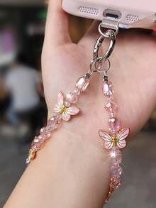 1 pieza Cordón de teléfono de lujo con mariposa, colgante de cristal delicado, correa de muñeca con cuentas hecha a mano, accesorio corto para teléfono