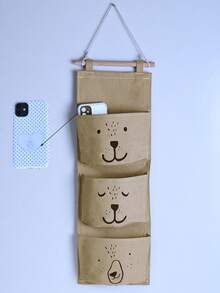 1 个可爱的悬挂式收纳袋，带有 3 个口袋，采用不同的笑脸熊图案。挂在床边、墙壁或门上，可轻松存放小物品，为您的生活增添温暖 - 不含挂钩（随机颜色）