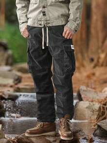 Pantaloni cargo da uomo in velluto a coste di colore unito, pantaloni con lacci e tasche multiple, pantaloni casual e larghi da esterno, pantaloni da lavoro e stile di strada da uomo