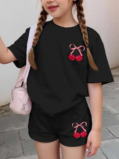 Set de 2 piezas de camiseta de manga corta y shorts casuales, con moño rosa adorable y estampado de cerezas, adecuado para niñas preadolescentes en verano