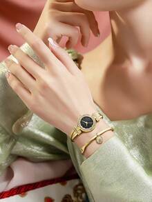 Anne Klein Damen-Armbanduhr mit goldfarbenem Kristall-Akzent und Armband im Set mit glänzendem schwarzem Zifferblatt, elegante Damen-Quarzarmbanduhr mit verstellbarem Armreif