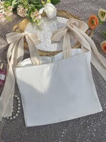 Top corto de mujer de un solo pieza, con diseño elegante y casual, hombros descubiertos, sin mangas, con detalles de lazo y silueta que favorece la figura