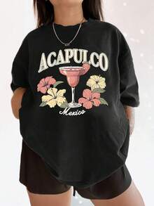 Camiseta para mujer con estampado de cóctel mexicano Acapulco y flor de hibisco, camiseta ligera de cuello redondo, top gráfico de vacaciones de verano tropical, perfecta para uso informal diario de gran tamaño. - Negro - Ver 1