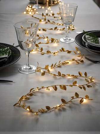 393.7 Inch 100 LED - Festive Gold Leaf LED String Lights For Holiday & Wedding. This Enchanting Garland On Flexible Copper Wire Weaves A Magical Glow For Any Celebration. Perfect For Your Christmas Party Decor, Romantic Wedding Backdrops, And Festive Event Centerpieces.