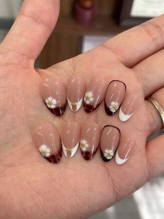 Las uñas postizas de forma almendrada, largas y de longitud media, en un set de 10 piezas, para un estilo elegante de otoño-invierno. La manicura estilo francés combina flores pintadas a mano y elementos ámbar, con pequeñas cuentas doradas añadidas.