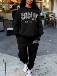 The Stylish And Elegant Simple Round Neck Pullover Sweatshirt Two Pieces Set For Autumn And Winter Features A Thick Flannel Style. The Round Neck Top Is Paired With Drawstring Pants, Showcasing A Fashionable Large Graphic Letter Combination Print Design. It Is Very Suitable For Casual Sports, Fitness Training, Outdoor Jogging, And Daily Wear At Home.