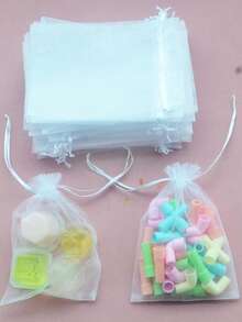 Bolsa de regalo de joyería transparente con cordón, se puede usar como decoración de regalo y es fácil de transportar, adecuada para bodas, despedidas de soltera, promociones de fiestas, exhibición de joyería y bolsas de regalo de Navidad. Estilo/color aleatorio de bolsa de caramelos