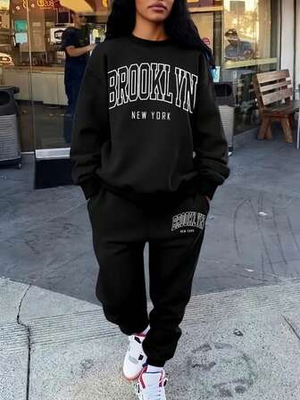 The Stylish And Elegant Simple Round Neck Pullover Sweatshirt Two Pieces Set For Autumn And Winter Features A Thick Flannel Style. The Round Neck Top Is Paired With Drawstring Pants, Showcasing A Fashionable Large Graphic Letter Combination Print Design. It Is Very Suitable For Casual Sports, Fitness Training, Outdoor Jogging, And Daily Wear At Home.