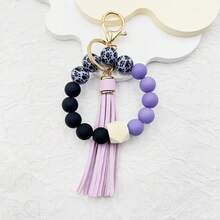 A Leopard Print Silicone Wood Bead Bracelet Keychain With PU Leather Tassels, Fashionable Bag Dration, And Women's Gift