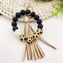 A Leopard Print Silicone Wood Bead Bracelet Keychain With PU Leather Tassels, Fashionable Bag Dration, And Women's Gift