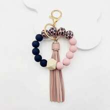 A Leopard Print Silicone Wood Bead Bracelet Keychain With PU Leather Tassels, Fashionable Bag Dration, And Women's Gift
