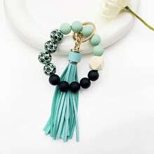 A Leopard Print Silicone Wood Bead Bracelet Keychain With PU Leather Tassels, Fashionable Bag Dration, And Women's Gift