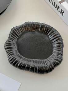 Una bandeja de joyería con forma irregular y floral, hecha a mano de cerámica cocida en horno, disponible en blanco clásico y negro elegante. Diseñada perfectamente para consolas de entrada, organiza tu joyería de manera eficiente mientras sirve como una pieza decorativa artística.