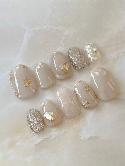 10片手工制作的按压式美甲贴片，短椭圆形，多种颜色可选，Y2K法式风格，优雅冰晶半透明极简猫眼和手绘花卉设计，适合女性和女孩，是秋冬派对和日常美甲的理想之选。