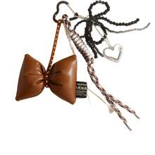 A DIY Bow-Shaped Hanging Ornament With Braiding And Heart Combination Decorations, Very Unique, Available In Multiple Colors. It Can Be Used As A Hanging Accessory In Cars, A Decoration For Women's Handbags, Bag Accessories, Backpack Accessories, Keychain Hangers, Personalized Gifts, Gifts For Children, Halloween, Birthdays, Back-To-School, Travel Souvenirs, Party Gatherings, Couple Gifts, And Wedding Gifts.