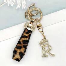 Breloc din aliaj de zinc, 1 bucată, cu design din piele PU imprimată, împreună cu un pandantiv strălucitor cu literă în formă de coroană, strat antirugină, potrivit pentru agățarea cheilor mașinii, cheilor etc. Se potrivește cu orice și este un accesoriu indispensabil pentru a purta!