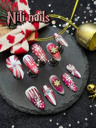 10 st. handgjorda vinterjulnaglar, medellånga mandelformade handgjorda press-on-naglar, röda kattögon och vita handritade snöflingor, rosett, presentpåse, rekommenderas för het tjej som strävar efter hantverk och kvalitetskonfiguration, 3D-snöflingedekoration lämplig för julbruk, och är fantastiska presenter till kvinnor och tjejer, utrustad med 1 gelépad och 1 nagelfil