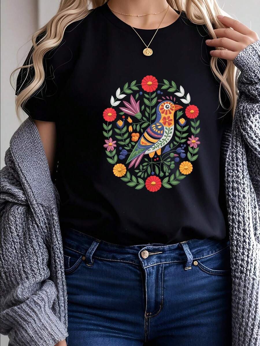 Camiseta con Estilo de Bordado Otomí Mexicano, Pájaros y Flores, diseño que honra el arte indígena otomí: pájaros con plumas decoradas y flores en patrones geométricos típicos, colores vibrantes (rojo, azul, amarillo) que siguen la tradición otomí, ajuste unisex y materiales orgánicos, perfecta para quienes quieren apoyar la cultura indígena - Negro - Ver 1