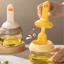 1 pieza Botella de aceite para barbacoa con forma de pato de dibujos animados, incluye un cepillo de aceite, agarre de silicona, puede contener aceite en su interior, cepillo para hornear, cepillo para barbacoa, fácil de limpiar, utensilio de cocina, diseño súper lindo, botella de aceite integrada.