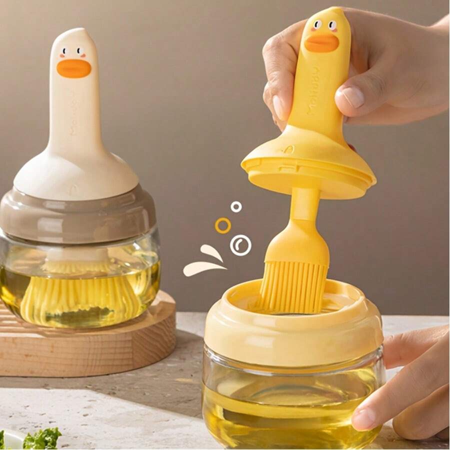 1 pieza Botella de aceite para barbacoa con forma de pato de dibujos animados, incluye un cepillo de aceite, agarre de silicona, puede contener aceite en su interior, cepillo para hornear, cepillo para barbacoa, fácil de limpiar, utensilio de cocina, diseño súper lindo, botella de aceite integrada.