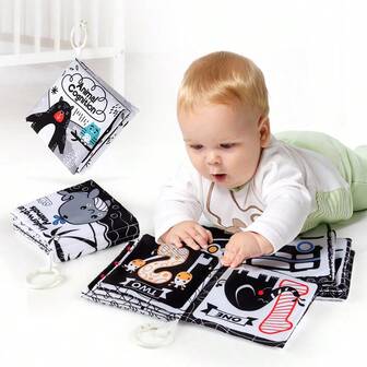 Black And White Three-Dimensional Cloth Book, With Themes Such As Animals And Numbers, Simple And Interesting Patterns, And A Circular Buckle That Can Be Hung On The Wall To Stimulate The Visual Development Of Babies