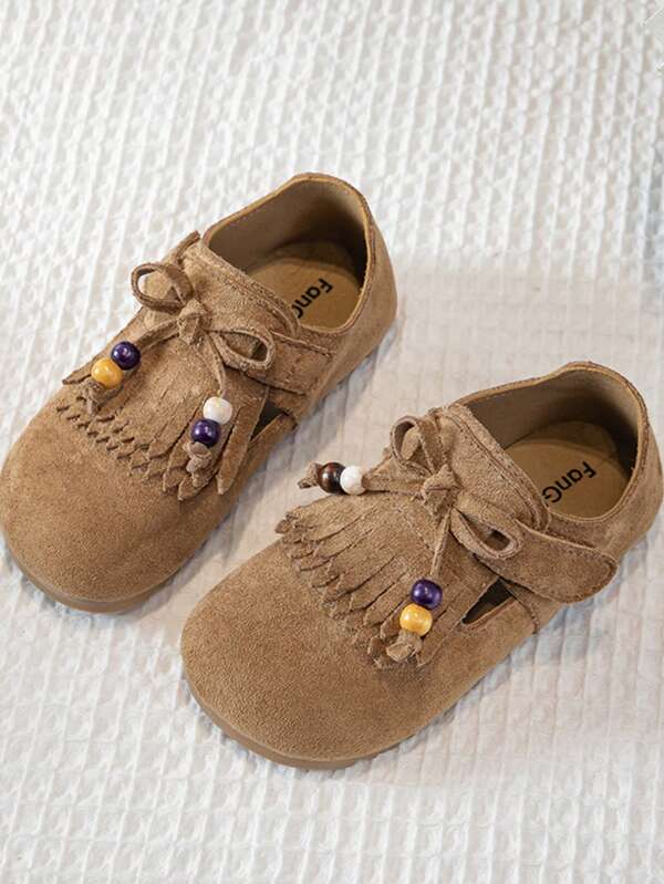 1 Paar Kinderschuhe für Jungen und Mädchen mit Quasten und Perlendekor (Quasten an der Zehenkappe, kombiniert mit Perlen), Material aus rutschfestem Leder (Obermaterial aus rutschfestem Leder), bequem und rutschfest, niedriges Oberteil (niedriges Oberteil), Klettverschluss (mit Klettverschluss befestigt), flach, Retro-Stil Schuhe, geeignet für tägliche Ausflüge im Frühling und Herbst, Teilnahme an folkloristischen Kinderaktivitäten und anderen Szenarien