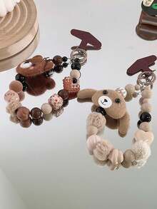 Correa versátil para funda de teléfono con estampado de leopardo, cadena de cordón con oso de peluche marrón cálido con pompón de peluche, adecuada para otoño/invierno