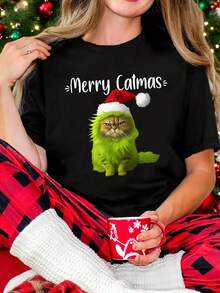 Camiseta Navideña Divertida de Gato para Mujeres - Inspirada en el Patrón "Merry Catmas", Diseño de Gato y Corazón, Top Casual de Manga Corta y Cuello Redondo, Adecuada para Amantes de los Gatos, Atuendo de Fiesta y Uso Diario (Lavable a Máquina, Estilo Primavera/Verano) - Regalo Perfecto para Damas Gato, Gato Verde Festivo con Estampado de Gorro y Bufanda de Santa, Adecuado para Fiestas Navideñas y Salidas Casuales, Tema Festivo Juguetón - Negro - Ver 1