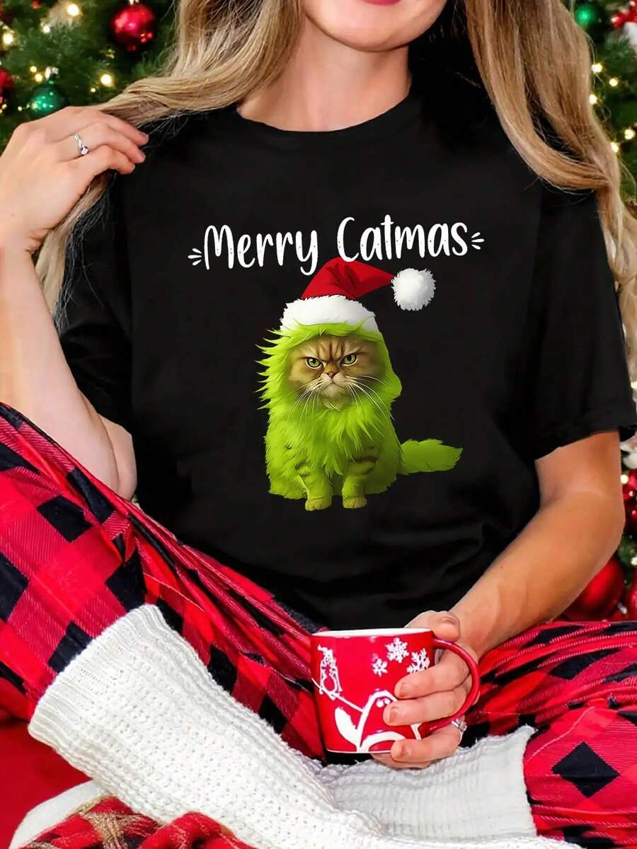 Camiseta Navideña Divertida de Gato para Mujeres - Inspirada en el Patrón "Merry Catmas", Diseño de Gato y Corazón, Top Casual de Manga Corta y Cuello Redondo, Adecuada para Amantes de los Gatos, Atuendo de Fiesta y Uso Diario (Lavable a Máquina, Estilo Primavera/Verano) - Regalo Perfecto para Damas Gato, Gato Verde Festivo con Estampado de Gorro y Bufanda de Santa, Adecuado para Fiestas Navideñas y Salidas Casuales, Tema Festivo Juguetón - Negro - Ver 1