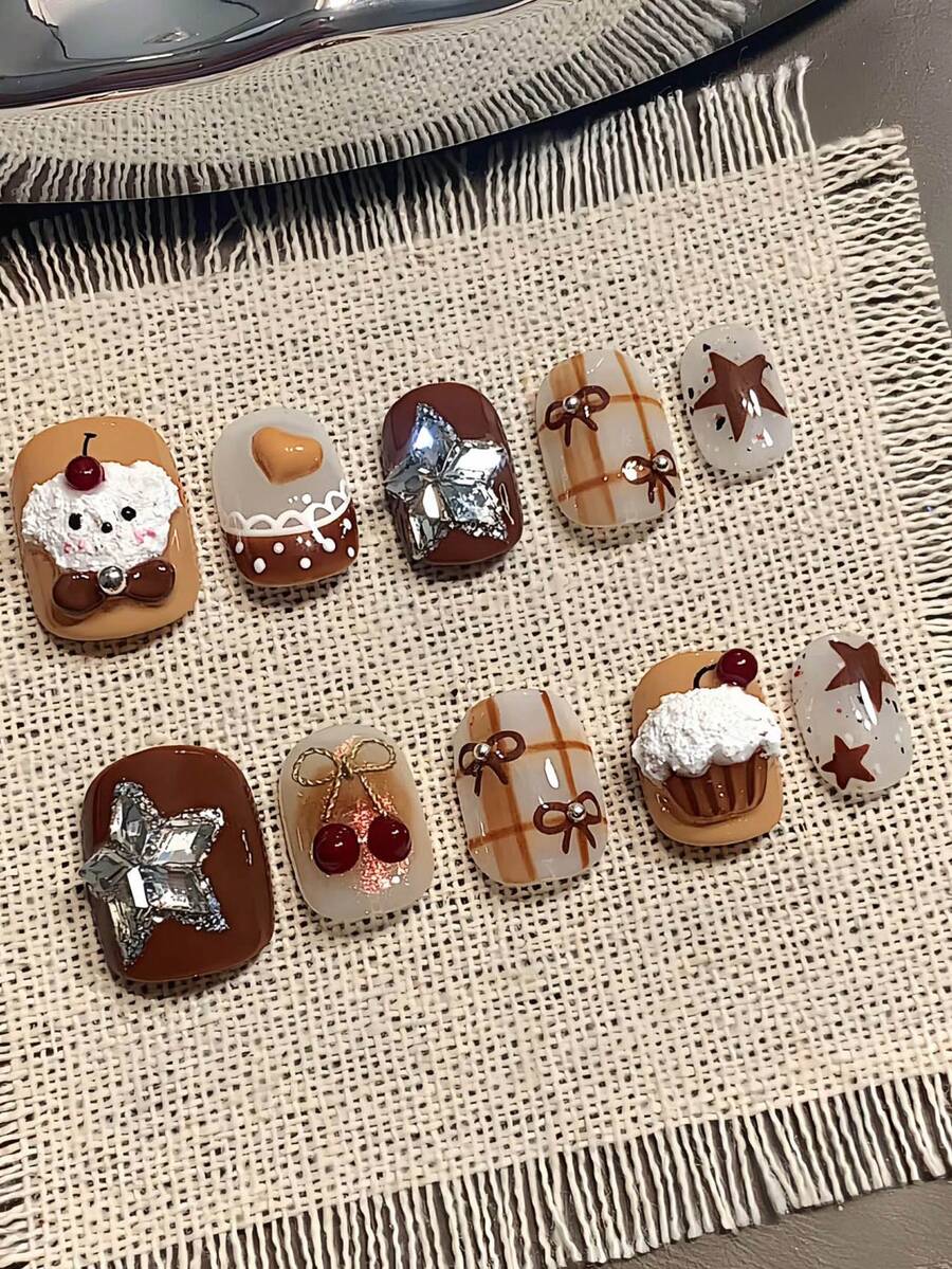 10片纯手工制作的按压式美甲贴片，短椭圆形，棕色，Y2K风格，卡通甜美精致，3D纸杯蛋糕装饰，星形蝴蝶结樱桃装饰，适合女性和女孩，秋冬季节庆派对、圣诞节及日常生活使用。 - 巧克力棕 - 查看 1