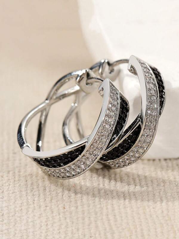 A Unique And Fashionable Black And White Woman Wearing A Pair Of Synthetic Cubic Zirconia Stud Earrings And Hoop Earrings, Very Distinctive.