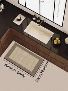 1块硅胶厨房垫，简约双色拼布图案。垫子主体为浅米色，纹理细密，类似编织，边缘为深棕色，形成清晰的区域划分。整体设计简洁大方。厨房垫风格奢华时尚，具有缓冲抗疲劳功能，表面为织物，中间为海绵吸水材质。