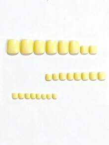 48片黄色纯色亮面人造指甲，浅黄色，适用于手指和脚趾，是DIY纯色美甲的理想之选，也适合约会和日常使用。可重复使用的按压式指甲套装，包含果冻胶和指甲锉。果冻胶颜色随机发货。