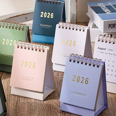 2026 ปฏิทินตั้งโต๊ะขนาดเล็ก - วางแผนรายเดือนและรายสัปดาห์, ทำจากกระดาษหนา 250 กรัม, เข้าเล่มแบบห่วงคู่, มีให้เลือกหลายสีสันสดใส (ชมพู, น้ำเงิน, เขียว, ขาว), เหมาะสำหรับใช้ในบ้านหรือสำนักงาน, สามารถใช้เป็นปฏิทินตั้งโต๊ะสำนักงาน, สมุดบันทึกเดสก์ท็อปสไตล์ Morandi สีทึบเรียบง่าย