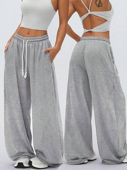 1件装女士加厚瑜伽训练宽松舒适日常健身跑步休闲柔软抽绳筒裤，带大口袋，适合秋冬季节穿着。