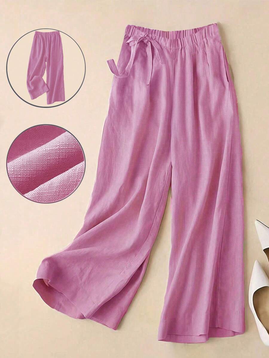 春夏新品，通勤休闲两相宜，优雅玫瑰红高腰侧系带阔腿裤。垂坠感亚麻混纺面料，七分裤长。松紧腰设计，显瘦拉长身形。口袋设计，舒适透气。纯色百搭，适合通勤和日常休闲穿着。宽松版型，时尚优雅。女士情人节穿搭，女士度假穿搭