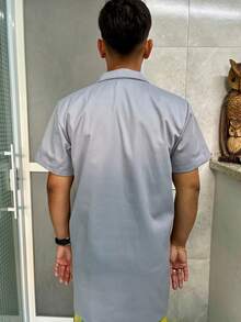 Camisa masculina de algodão liso, manga curta, com botões frontais e bolsos, comprimento regular e gola assimétrica