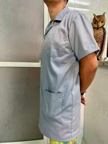 Camisa masculina de algodão liso, manga curta, com botões frontais e bolsos, comprimento regular e gola assimétrica